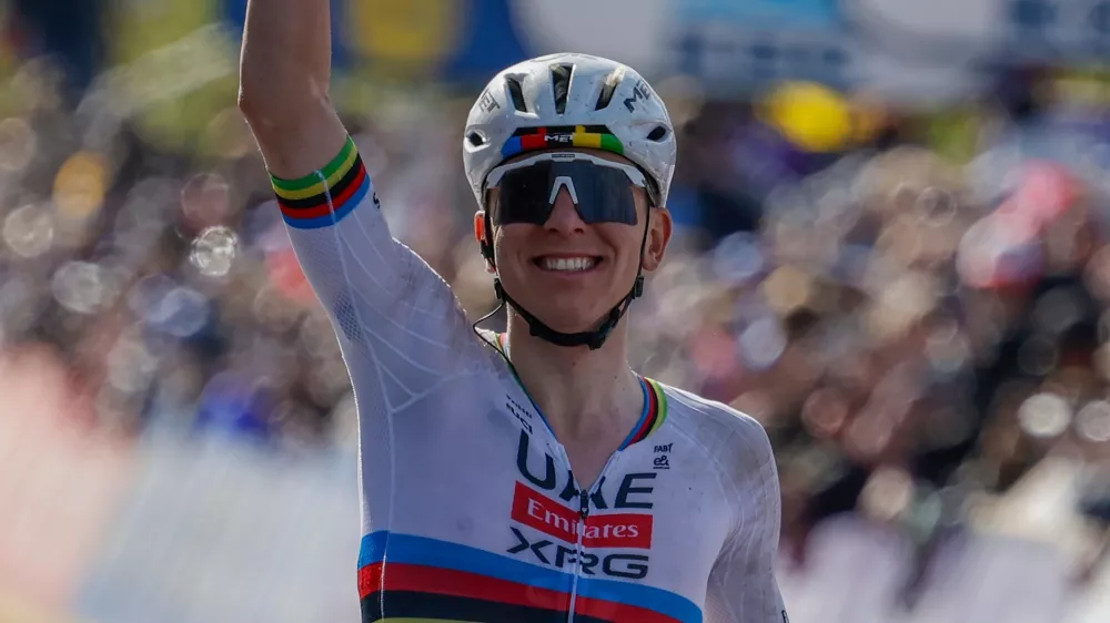 Slovenia's Tadej Pogacar crosses the finish line to win the Tour of Flanders cycling race, in Oudenaarde, Belgium Sunday, April 5, 2026. (AP Photo/Geert Vanden Wijngaert)