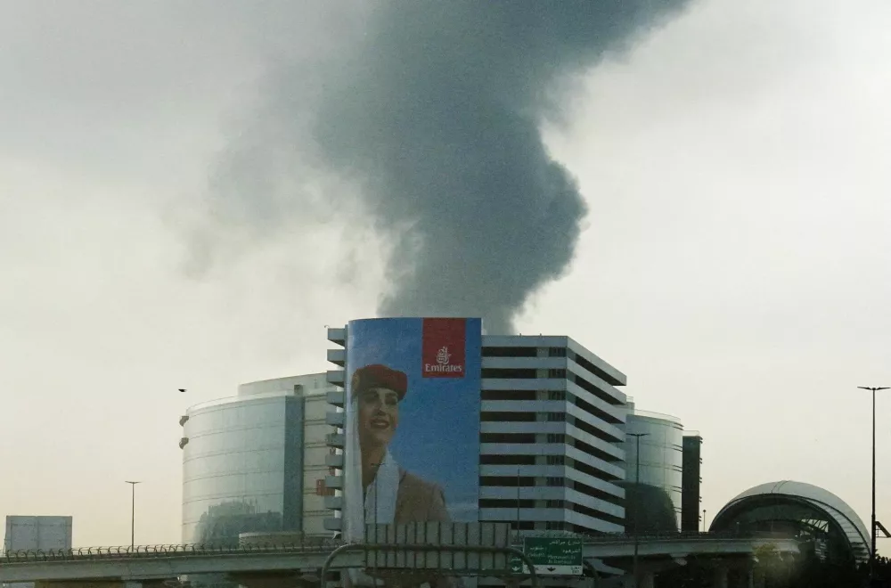 FILE PHOTO: Smoke rising from an area near the Dubai International Airport is seen through the windshield of a vehicle, after a drone attack hit a fuel tank, according to Dubai authorities, amid the U.S.-Israel conflict with Iran, in Dubai, United Arab Emirates, March 16, 2026, REUTERS/Stringer/File Photo