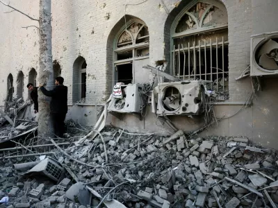 People stand amidst the rubble of a building of the Sharif University of Technology, which was damaged in a strike, amid the U.S.-Israeli conflict with Iran, in Tehran, Iran, April 7, 2026. Majid Asgaripour/WANA (West Asia News Agency) via REUTERS ATTENTION EDITORS - THIS PICTURE WAS PROVIDED BY A THIRD PARTY   TPX IMAGES OF THE DAY