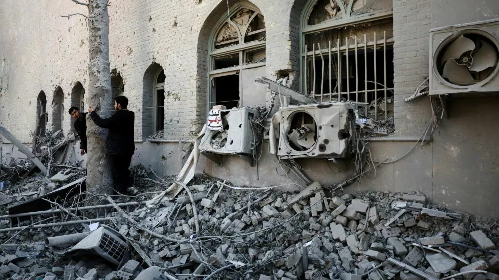 People stand amidst the rubble of a building of the Sharif University of Technology, which was damaged in a strike, amid the U.S.-Israeli conflict with Iran, in Tehran, Iran, April 7, 2026. Majid Asgaripour/WANA (West Asia News Agency) via REUTERS ATTENTION EDITORS - THIS PICTURE WAS PROVIDED BY A THIRD PARTY   TPX IMAGES OF THE DAY