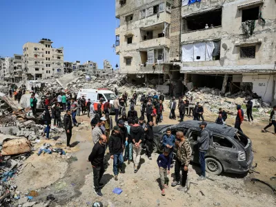 Palestinians inspect the damage after a person was hit by an Israeli strike while riding a bicycle, according to medics, in Gaza City, April 6, 2026. REUTERS/Dawoud Abu Alkas