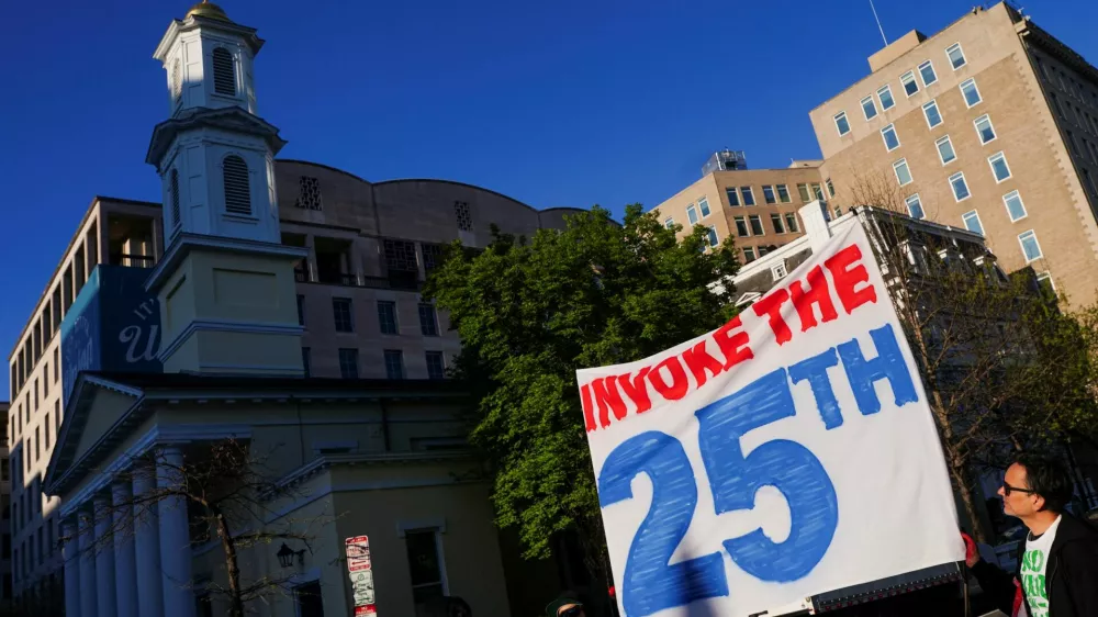 Demonstrators hold a banner during a protest against military action in Iran after U.S. President Donald Trump said that he had agreed to a two-week ceasefire with Iran, less than two hours before his deadline for Tehran to reopen the Strait of Hormuz or face widespread attacks on its civilian infrastructure, outside the White House in Washington, D.C., U.S., April 7, 2026. REUTERS/Nathan Howard