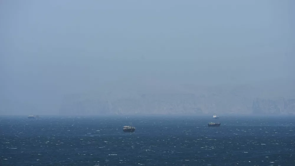 Vessels are off the coast of Musandam governorate, overlooking the strait of Hrmuz, in Musandam governance, in Oman, April 8, 2026.REUTERS/Stringer