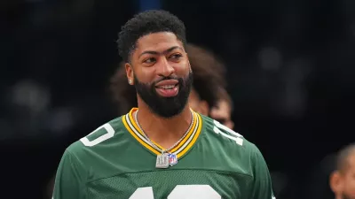 Dallas Mavericks forward Anthony Davis wears a NFL quarterback Jordan Love, of the Green Bay Packers, during the first half of an NBA basketball game against the Portland Trail Blazers Sunday, Nov. 16, 2025, in Dallas. (AP Photo/Julio Cortez)