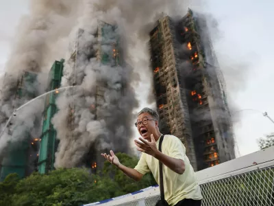 Mr Wong cries out in anguish as fire engulfs the Tai Po housing complex he calls home. Moments earlier, he phoned his wife, who was trapped in the building, and they exchanged what would be their final words. Hong Kong, 26 November 2025 Photograph: Tyrone Siu, Reuters/World Press Photo 2026