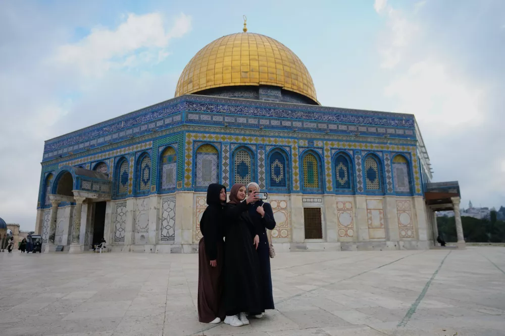 A Muslim women take a selfie next to the Dome of Rock shrine at Al-Aqsa Mosque compound following a ceasefire reached between Iran, Israel and the United States. in Jerusalem's Old City, Thursday, April 9, 2026. (AP Photo/Mahmoud Illean)