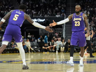 Los Angeles Lakers center Deandre Ayton (5) celebrates with forward LeBron James (23) during the second half of an NBA basketball game against the Golden State Warriors in San Francisco, Thursday, April 9, 2026. (AP Photo/Jeff Chiu)