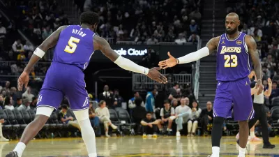 Los Angeles Lakers center Deandre Ayton (5) celebrates with forward LeBron James (23) during the second half of an NBA basketball game against the Golden State Warriors in San Francisco, Thursday, April 9, 2026. (AP Photo/Jeff Chiu)