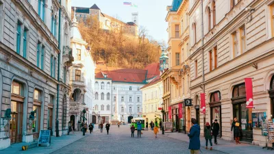 Ljubljana, Slovenia - January 15, 2019: Tourists on Stritarjeva Ulica Street and cityscape of Ljubljana old town with Castle, Slovenia, Europe. People in Slovenian city view in winter. Urban capital.