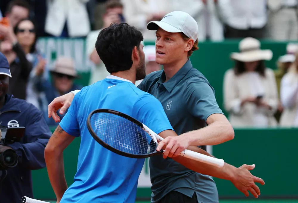 Tennis - ATP Masters 1000 - Monte Carlo Masters - Monte Carlo Country Club, Roquebrune-Cap-Martin, France - April 12, 2026 Italy's Jannik Sinner hugs Spain's Carlos Alcaraz after winning their final match REUTERS/Manon Cruz