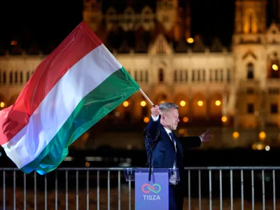 Peter Magyar, the leader of the opposition Tisza party waves a national flag after a parliamentary election in Budapest, Hungary, Sunday, April 12, 2026. (AP Photo/Darko Bandic)