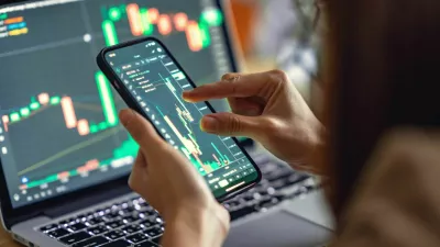 Closeup - Woman is checking Bitcoin price chart on digital exchange on smartphone, cryptocurrency future price action prediction.