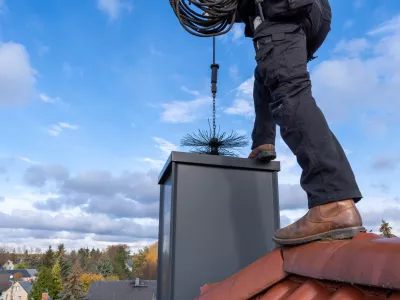 chimney sweep with stovepipe hat upon the roof
