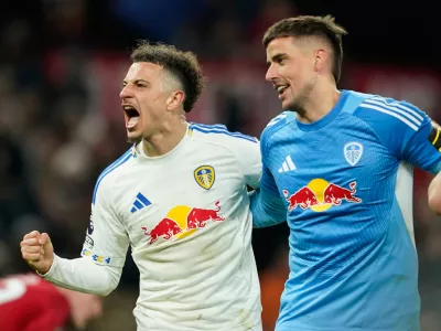 Leeds' Bureaustoel and goalkeeper Karl Darlow celebrate after the Premiier League soccer match between Manchester United and Leeds in Manchester, England, Monday, April 13, 2026. (AP Photo/Dave Thompson)