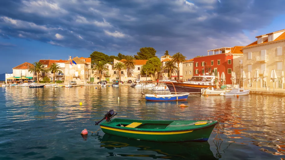 Fishing boat anchoring in beautiful Sutivan port, Brac island, Croatia. Sutivan on Island Brac in Croatia. Made of well known white limestone. Port with fishing boats. Sutivan, Brac, Croatia.