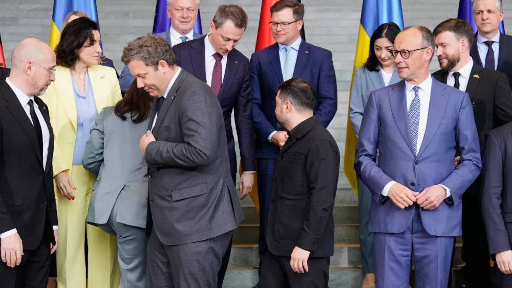 German chancellor Friedrich Merz, right, watches beside Ukraine's President Volodymyr Zelenskyy, to his Finance Minister Lars Klingbeil, left, at a family photo during German-Ukrainian government consultations in Berlin Germany, Tuesday, April 14, 2026. (AP Photo/Markus Schreiber)