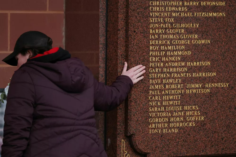 Soccer Football - UEFA Champions League - Quarter Final - Second Leg - Liverpool v Paris St Germain - Anfield, Liverpool, Britain - April 14, 2026 A fan next to a memorial of victims of the Hillsborough disaster ahead of it's 27th anniversary outside the stadium before the match REUTERS/Phil Noble