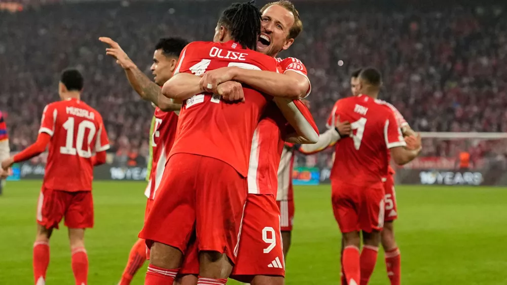 Bayern's Michael Olise celebrates with Harry Kane after scoring his side's fourth goal uring the Champions League quarterfinal second leg soccer match between Bayern Munich and Real Madrid in Munich, Germany, Wednesday, April 15, 2026. (AP Photo/Matthias Schrader)