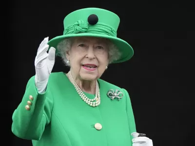Queen Elizabeth II waves to the crowd during the Platinum Jubilee Pageant at the Buckingham Palace in London, Sunday, June 5, 2022, on the last of four days of celebrations to mark the Platinum Jubilee. The pageant will be a carnival procession up The Mall featuring giant puppets and celebrities that will depict key moments from the Queen Elizabeth II's seven decades on the throne. (AP Photo/Frank Augstein, Pool)