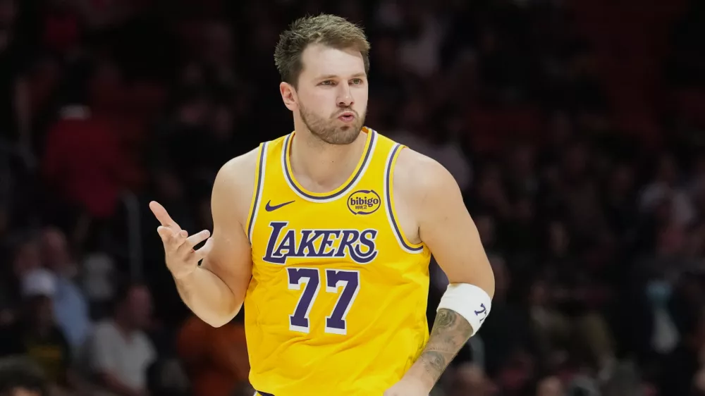 Los Angeles Lakers guard Luka Doncic (77) reacts after scoring during the second half of an NBA basketball game against the Miami Heat, Thursday, March 19, 2026, in Miami. (AP Photo/Lynne Sladky)