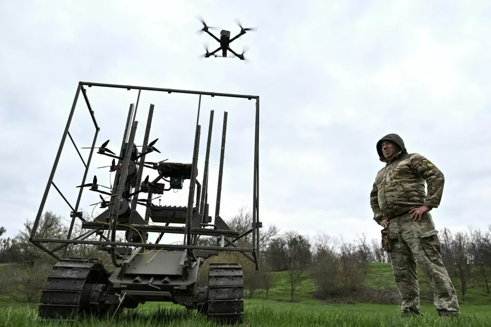 Ukrainian servicemen launch radio controlled and optic fibre controlled FPV-drones from an unmanned ground vehicle during testing at a training ground near a front line, amid Russia's attack on Ukraine, in Zaporizhzhia region, Ukraine April 10, 2026. REUTERS/Stringer