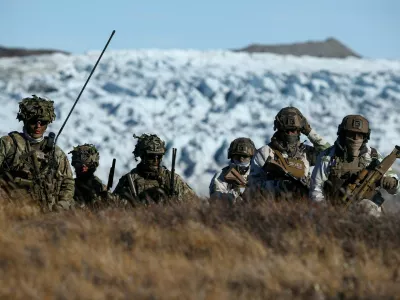 FILE PHOTO: Danish troops practice looking for potential threats during a military drill as Danish, Swedish and Norwegian home guard units together with Danish, German and French troops take part in joint military drills in Kangerlussuaq, Greenland, September 17, 2025. REUTERS/Guglielmo Mangiapane/File Photo