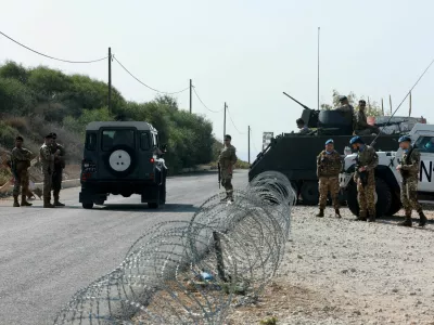 FILE PHOTO: United Nations peacekeepers (UNIFIL) and Lebanese army soldiers stand guard at a checkpoint in Naqoura, near the Lebanese-Israeli border, southern Lebanon, October 27, 2022. REUTERS/Aziz Taher/File Photo