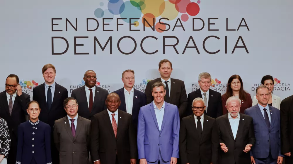 Spain's Prime Minister Pedro Sanchez, center, poses with attendees, at the Meeting in Defence of Democracy summit in Barcelona, Spain, Saturday, April 18, 2026. (AP Photo/Joan Monfort)