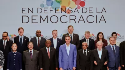 Spain's Prime Minister Pedro Sanchez, center, poses with attendees, at the Meeting in Defence of Democracy summit in Barcelona, Spain, Saturday, April 18, 2026. (AP Photo/Joan Monfort)