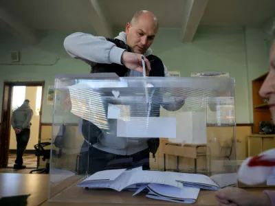 A man casts his ballot during an early election at a polling station in Sofia on Sunday, April 19, 2026. (AP Photo/Valentina Petrova)