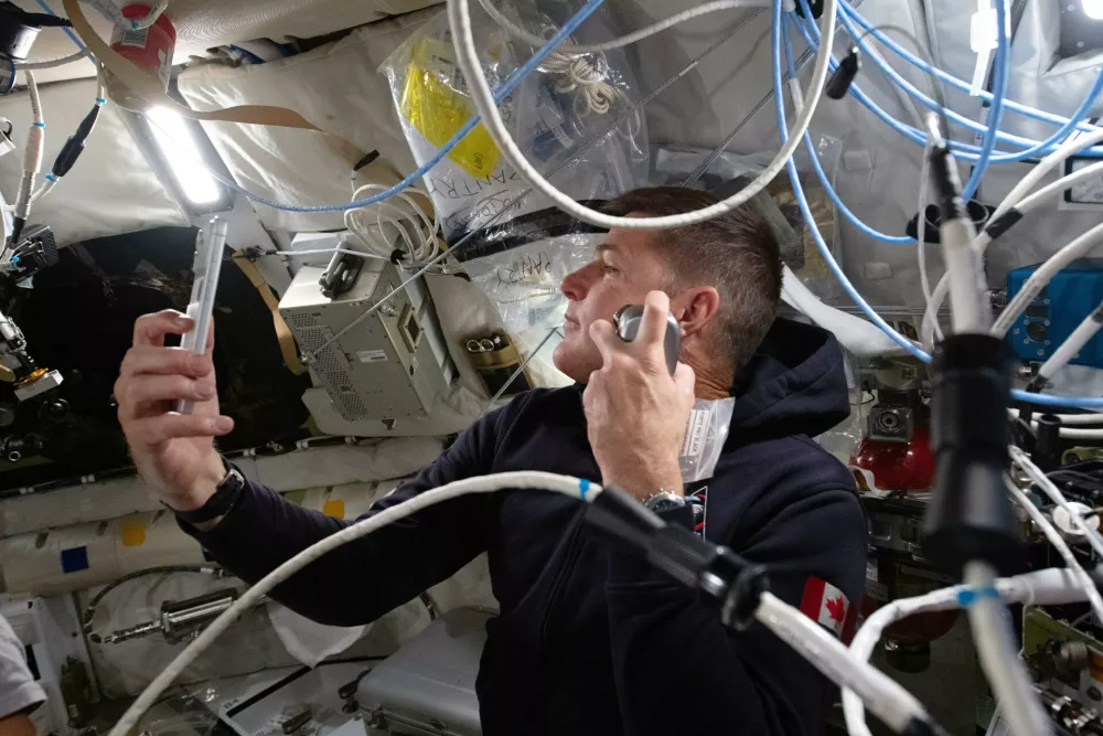 In this photo provided by NASA, Artemis II mission specialist and CSA (Canadian Space Agency) astronaut Jeremy Hansen enjoys a shave inside the Orion spacecraft during Flight Day 5 and ahead of the crew's lunar flyby, Monday, April 6, 2026. (NASA via AP)