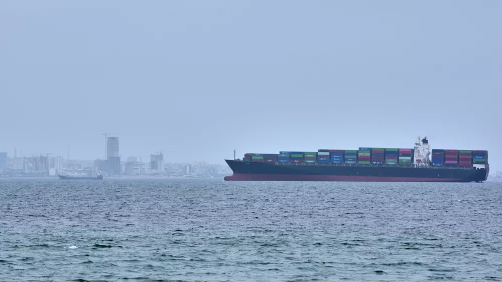A container ship is seen in the Strait of Hormuz off the coast of Qeshm Island, Iran, Saturday, April 18, 2026. (AP Photo/Asghar Besharati)