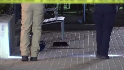 This image made from video provided by KCRG shows Iowa City police officers working the scene of a downtown shooting near the University of Iowa campus on Sunday, April 19, 2026. (KCRG via AP)