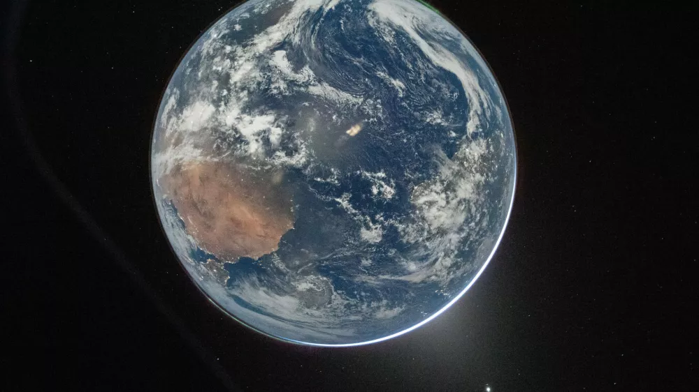 This image provided by NASA shows a view of Earth taken by NASA astronaut and Artemis II Commander Reid Wiseman from of the Orion spacecraft's window after completing the translunar injection burn on April 2, 2026. (NASA via AP)