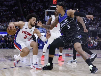 Apr 19, 2026; Detroit, Michigan, USA; Detroit Pistons guard Cade Cunningham (2) dribbles defended by Orlando Magic forward Paolo Banchero (5) in the second half during the 2026 NBA Playoffs at Little Caesars Arena. Mandatory Credit: Rick Osentoski-Imagn Images
