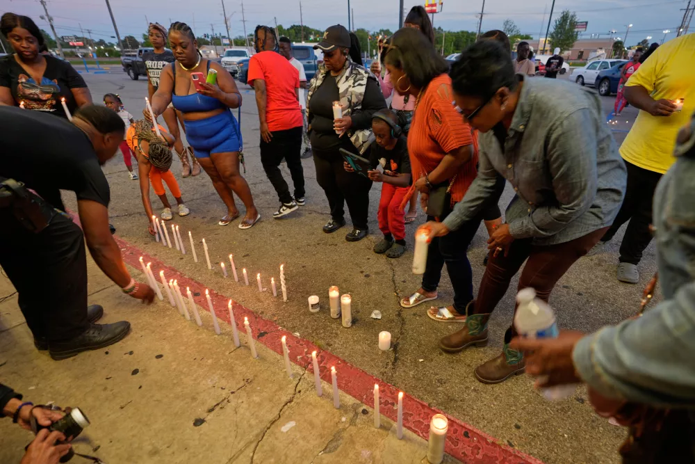 People light candles during a prayer vigil for the victims of a mass shooting earlier in the day, Sunday, April 19, 2026, in Shreveport, La. (AP Photo/Gerald Herbert)