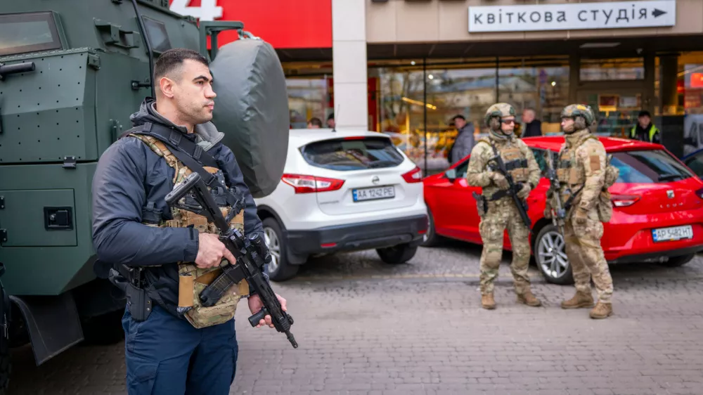 Police officers are seen at the site where a gunman killed at least six people in the streets before being shot dead by police, in Kyiv, Ukraine, Saturday, April 18, 2026. (AP Photo/Dan Bashakov)