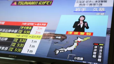 A television screen shows a news report on Japan Meteorological Agency's tsunami warning, saying it expected tsunami waves of up to 3 meters (9.84 feet) to reach large coastal areas in northern Japan after an earthquake with a preliminary magnitude of 7.4 struck off the northeastern coast of Japan, in Tokyo, Japan April 20, 2026.REUTERS/Issei Kato