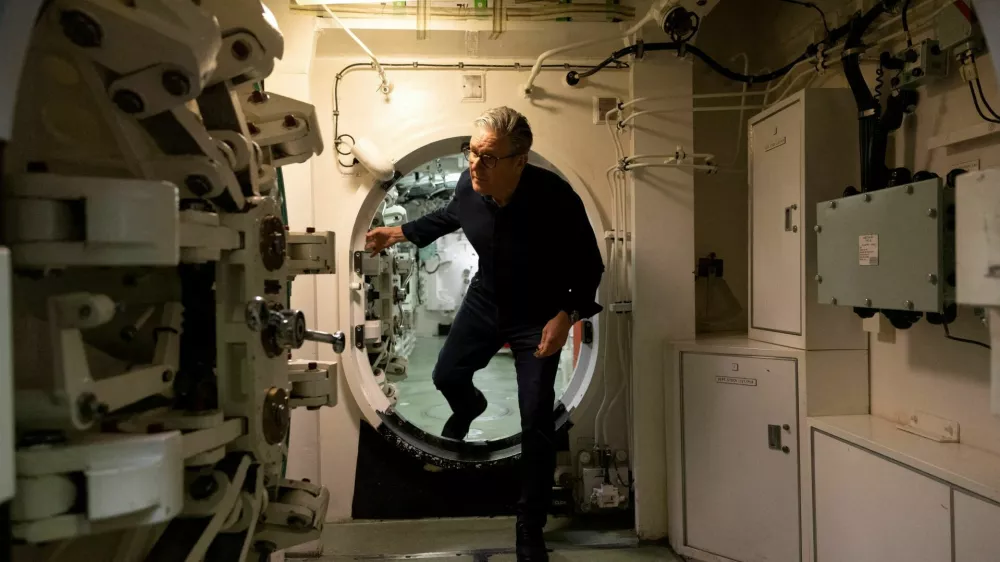 British Prime Minister Keir Starmer moves through a hatch on a Vanguard-class submarine, in Helensburgh, Scotland, Britain, April 18, 2026. Simon Dawson/UK MoD Crown Copyright/Handout via REUTERS ATTENTION EDITORS - THIS IMAGE HAS BEEN SUPPLIED BY A THIRD PARTY TPX IMAGES OF THE DAY