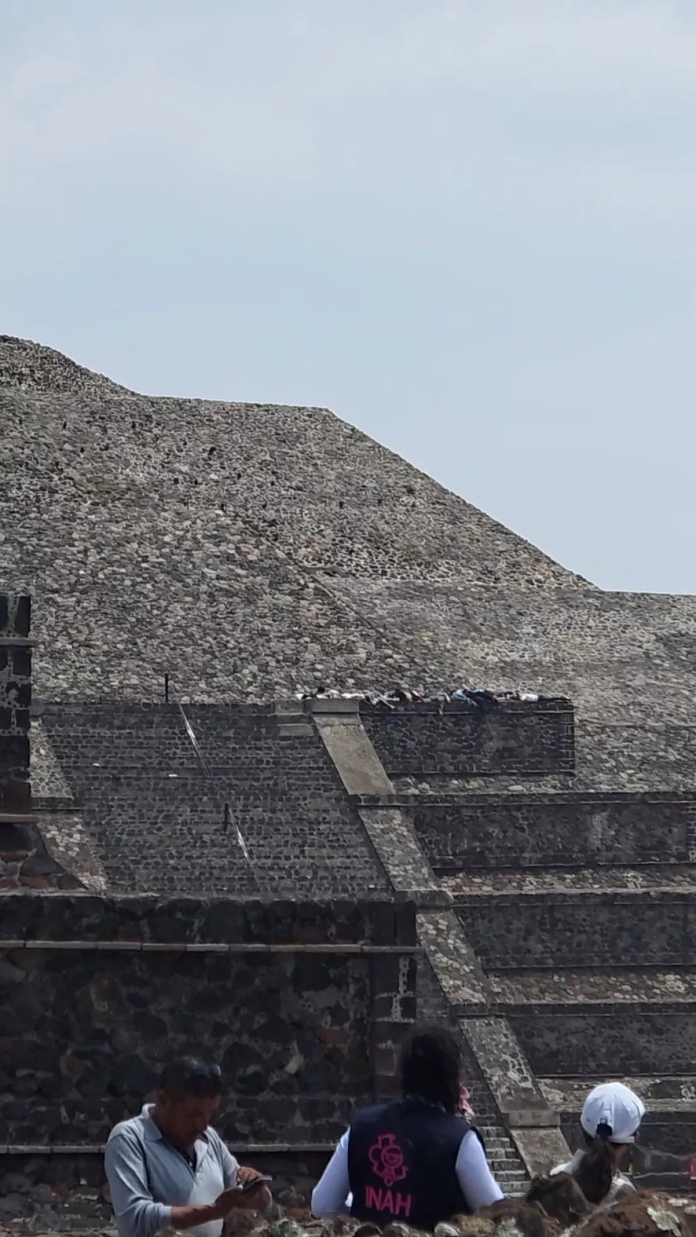 Onlookers observe people lying on the steps of a pyramid during an incident where authorities say a Canadian woman was shot dead and several others injured before the gunman killed himself at the Teotihuacan pyramids, a popular tourist and archaeological site, in San Martin de las Piramides, on the outskirts of Mexico City, Mexico, April 20, 2026, in this still image obtained from social media video. Video obtained by REUTERS THIS IMAGE HAS BEEN SUPPLIED BY A THIRD PARTY. MANDATORY CREDIT. NO RESALES. NO ARCHIVES Verification: - Road and pyramids layout matched the file and satellite imagery of the Teotihuacan archaeological site - Date verified by original file metadata, corroborating eyewitness footage and Reuters coverage of the aftermath.