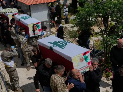 Mourners carry the coffins of civilians who were killed in the war between Hezbollah and Israel during a mass funeral in Bazouriyeh village, south Lebanon, Monday, April 20, 2026. (AP Photo/Mohammed Zaatari)