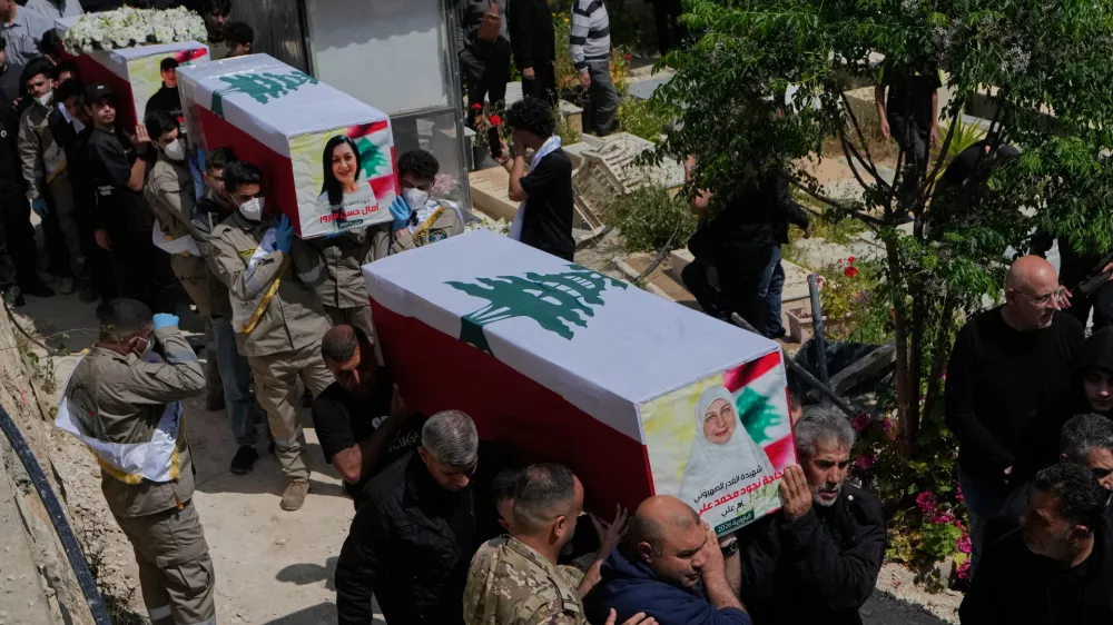 Mourners carry the coffins of civilians who were killed in the war between Hezbollah and Israel during a mass funeral in Bazouriyeh village, south Lebanon, Monday, April 20, 2026. (AP Photo/Mohammed Zaatari)