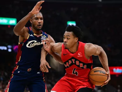 Apr 20, 2026; Cleveland, Ohio, USA; Toronto Raptors forward Scottie Barnes (4) drives on Cleveland Cavaliers center Evan Mobley (4) during the second half during game two of the first round of the 2026 NBA Playoffs at Rocket Arena. Mandatory Credit: David Dermer-Imagn Images