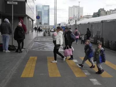 A refugee woman with children walk at the central train station in Warsaw, Poland, Thursday, April 7, 2022. (AP Photo/Czarek Sokolowski)