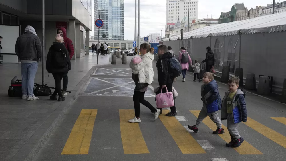 A refugee woman with children walk at the central train station in Warsaw, Poland, Thursday, April 7, 2022. (AP Photo/Czarek Sokolowski)