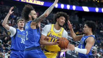 Los Angeles Lakers center Jaxson Hayes (11) secures a rebound against Dallas Mavericks center Dereck Lively II (2) and guard Ryan Nembhard (9) during the first half of a preseason NBA basketball game Wednesday, Oct. 15, 2025, in Las Vegas. (AP Photo/Ian Maule)