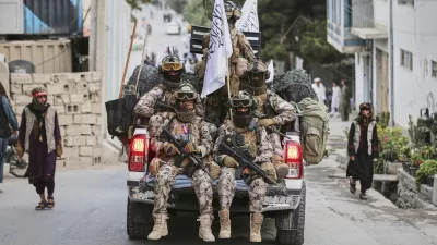 Taliban fighters parade in the streets during the celebrations marking the fourth anniversary of the U.S. withdrawal and the start of Taliban rule in Kabul, Afghanistan, Friday, Aug. 15, 2025. (AP Photo/Siddiqullah Alizai)