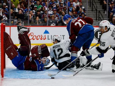 Apr 21, 2026; Denver, Colorado, USA; Colorado Avalanche goaltender Scott Wedgewood (41) watches as Los Angeles Kings right wing Quinton Byfield (55) is unable to control the puck as left wing Trevor Moore (12) and defenseman Brett Kulak (27) defend in the third period in game two of the first round of the 2026 Stanley Cup Playoffs at Ball Arena. Mandatory Credit: Isaiah J. Downing-Imagn Images