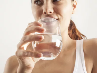Young woman drinking glass of water