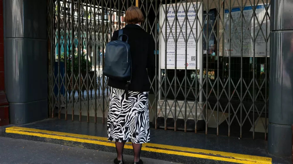 A woman looks at an information board outside a closed Covent Garden underground station during 24-hour tube strikes represented by the RMT union in dispute with TFL over working patterns, in London, Britain, April 22, 2026. REUTERS/Hannah McKay